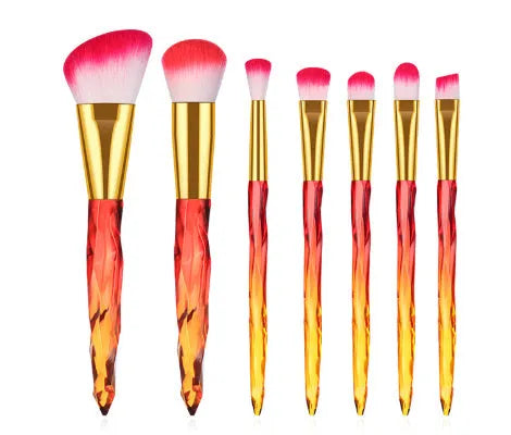 Ten crystal-handled foundation brushes with artificial fibre bristles in black, blue, red, and yellow.