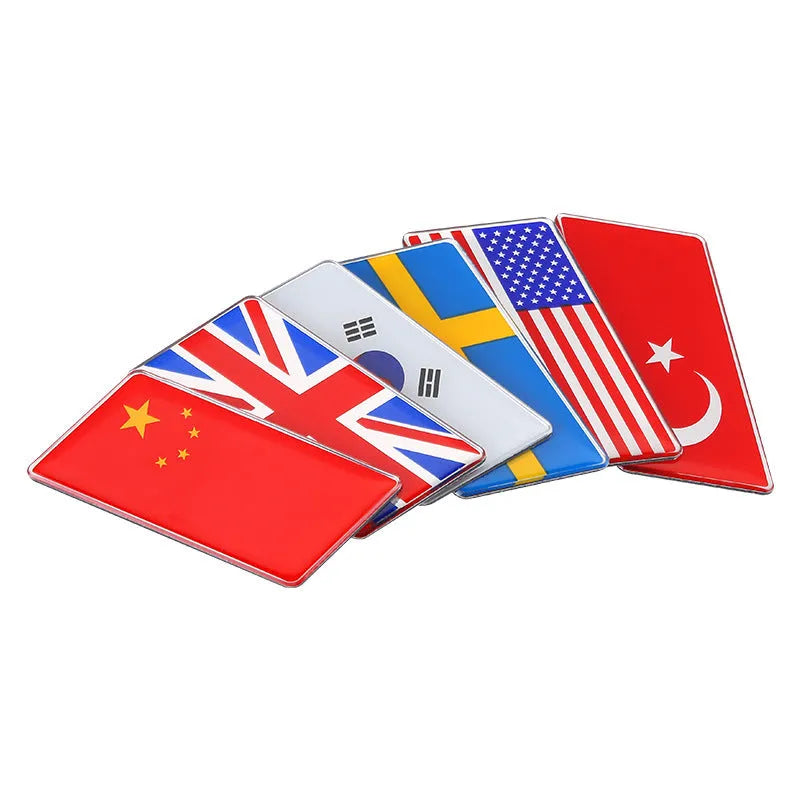 Aluminium metal car sticker with national flag design in a parallelogram shape.