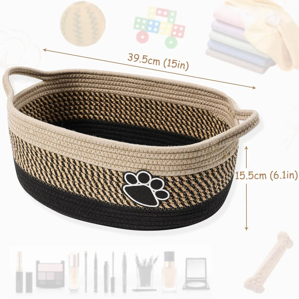 Small light beige handmade cotton rope storage basket with wooden handle on a table.