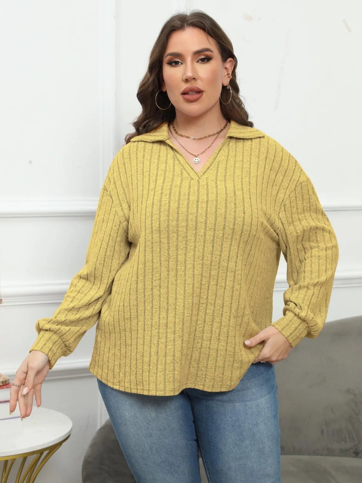 Women's plus size gray fleece pullover with a polo collar and full lantern sleeves.