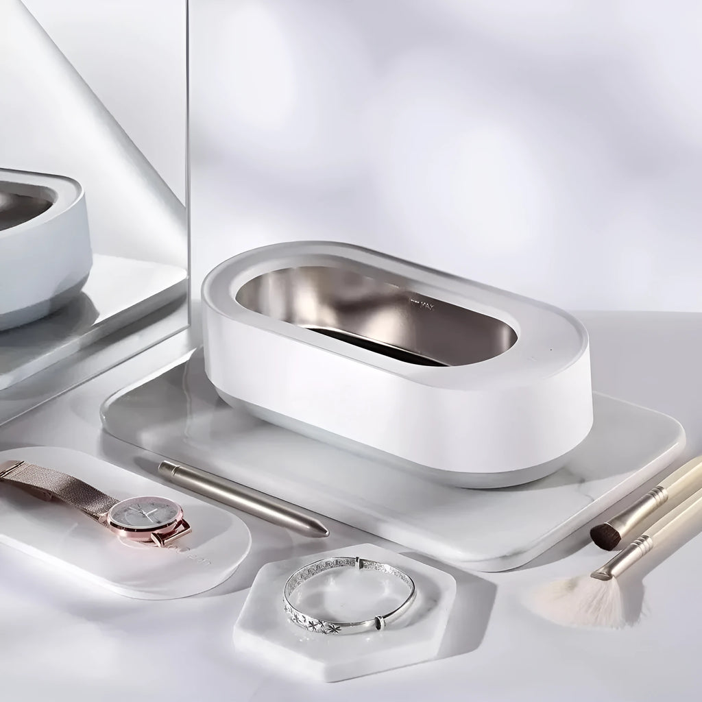 White portable ultrasonic cleaner machine with stainless steel tank for cleaning jewellery and glasses.