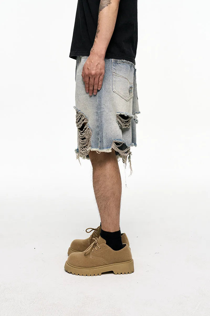 Light blue men's baggy denim shorts with a wide leg and mid waist on a plain background.