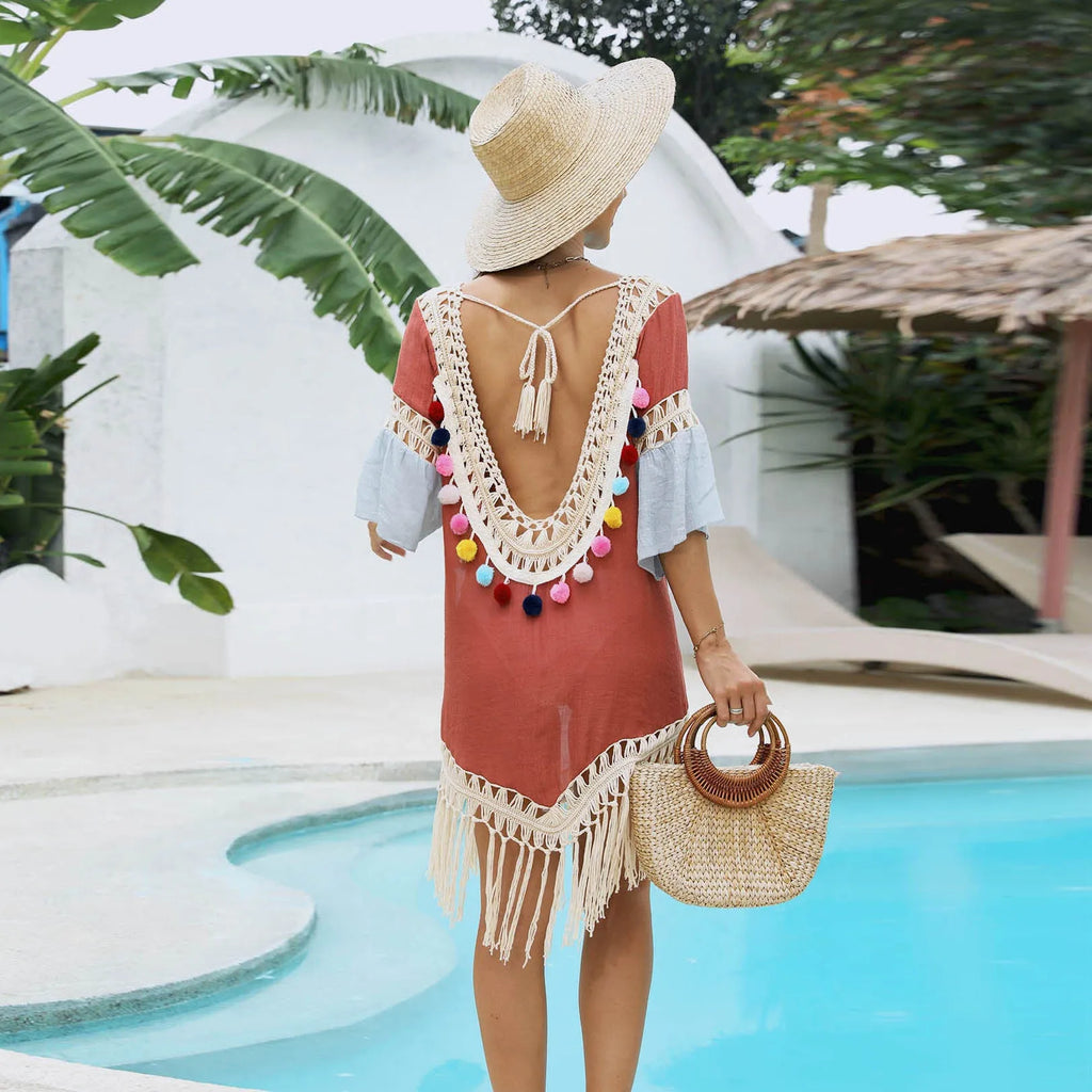 Orange floral pattern beach overskirt blouse with crochet stitching and tassel trim.