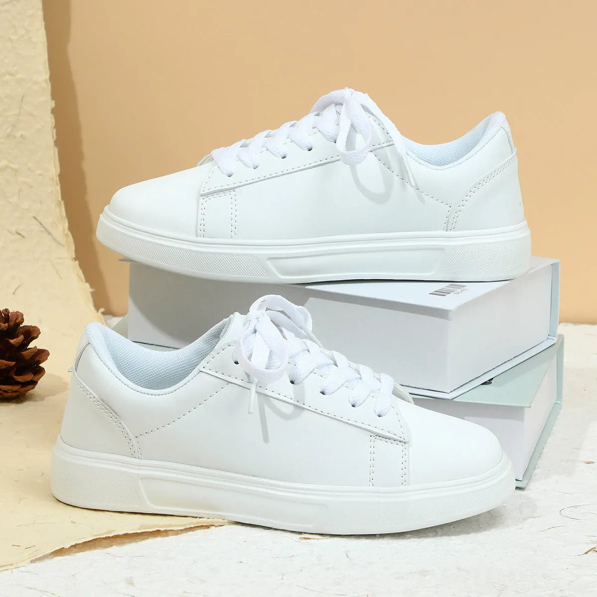 Beige brown platform skateboard sneaker with low top, round toe, and cross-belt design on a white background.
