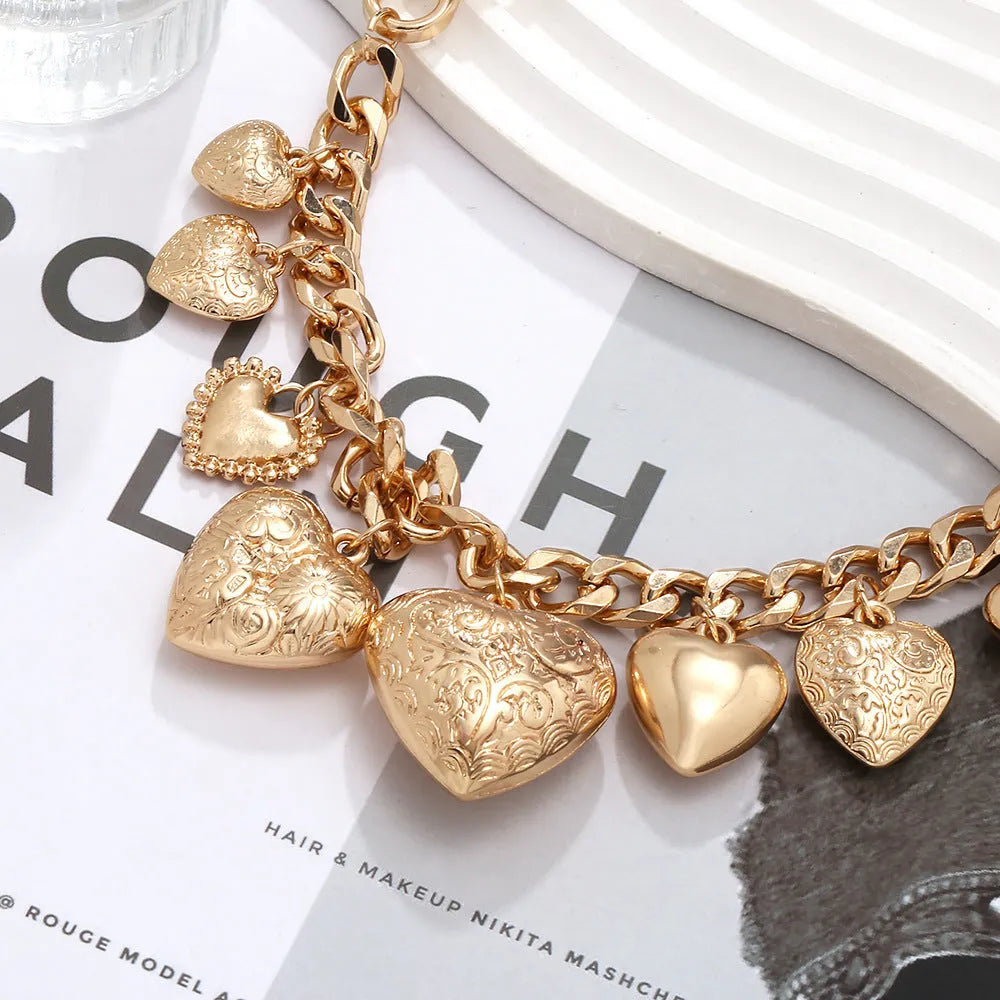 Exaggerated carved heart pendant necklace in gold or white K on an adjustable metal chain.