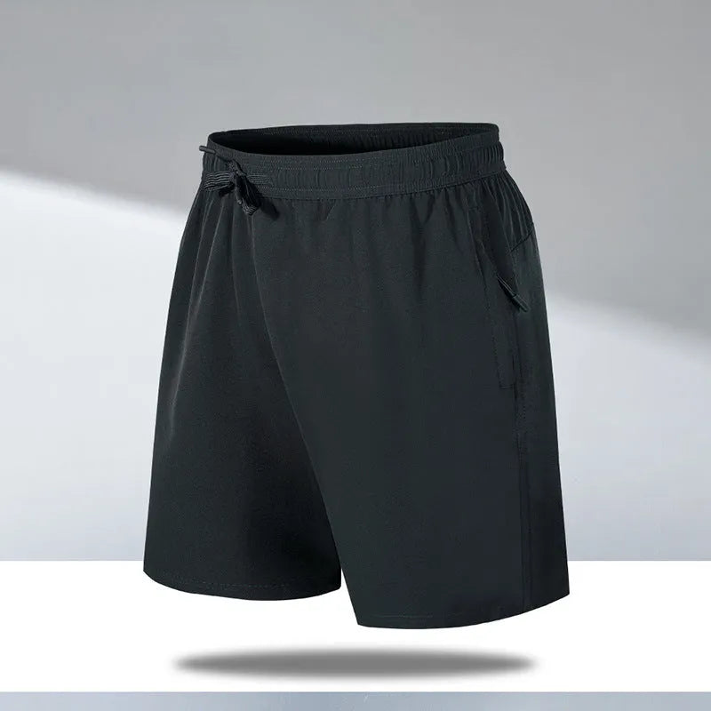 Man wearing loose black quick-dry sports shorts with an elastic waistband