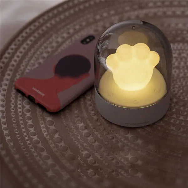 Grey cat paw shaped USB rechargeable night light with rotating musical display