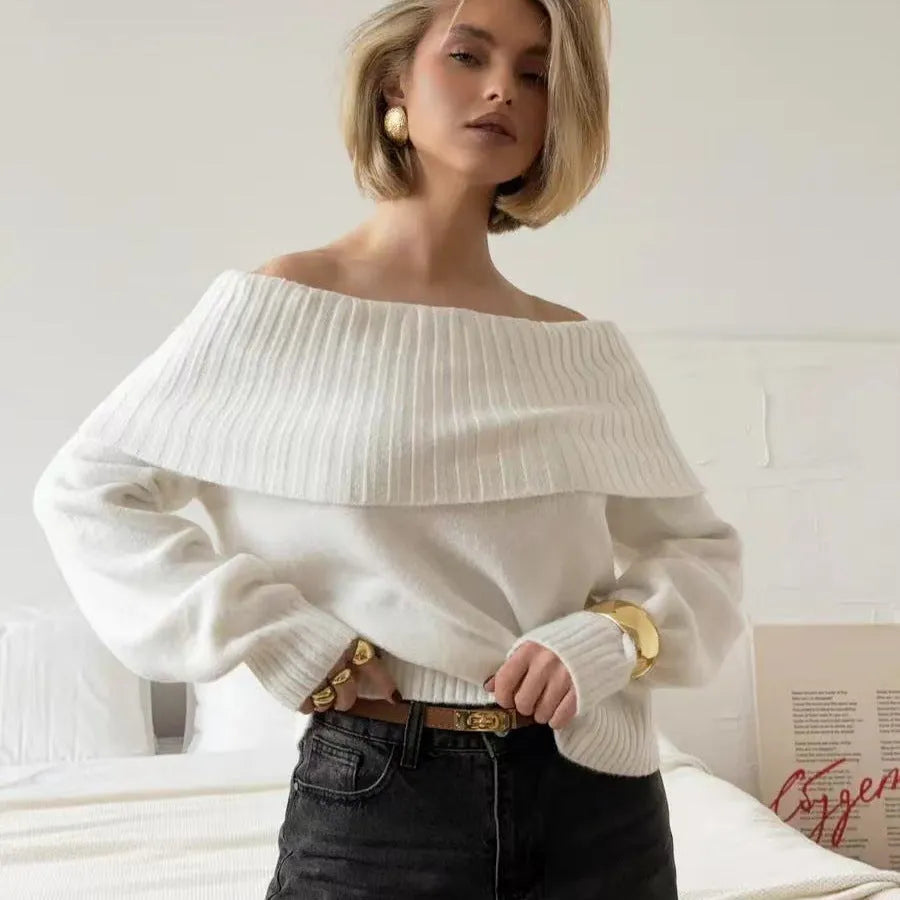 Woman wearing a grey off-the-shoulder strapless sweater with a 3D textured pattern.