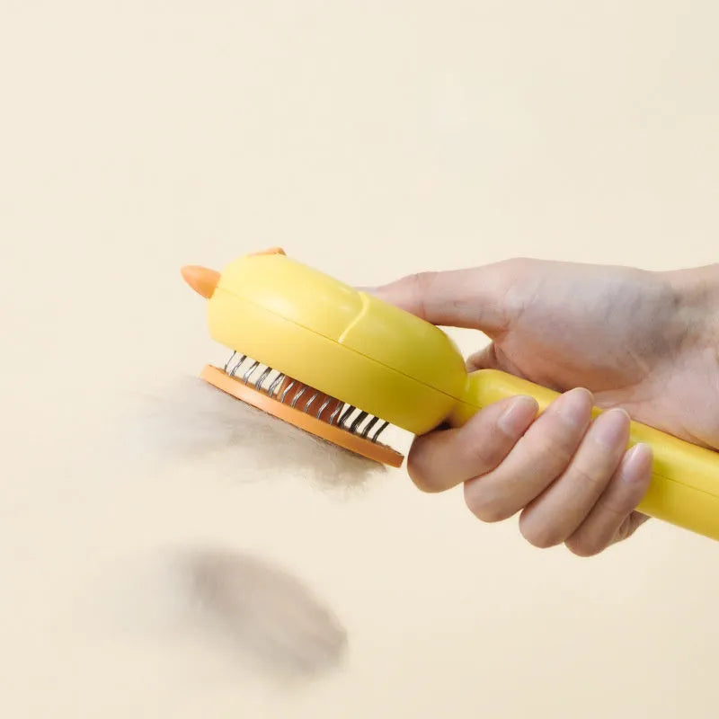 Purple pet grooming brush with stainless steel bristles and cleaning button