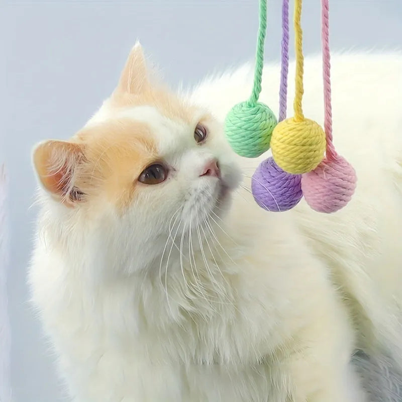 Green and pink soft plush cat toy balls with rope tails and internal bells