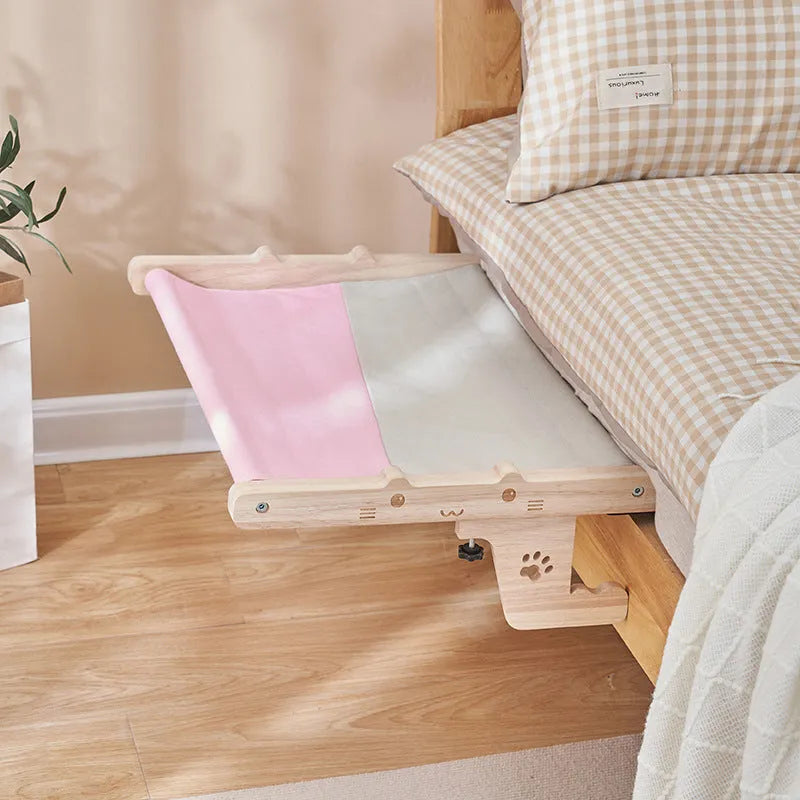 Wooden cat hanging bed hammock mounted on a balcony railing
