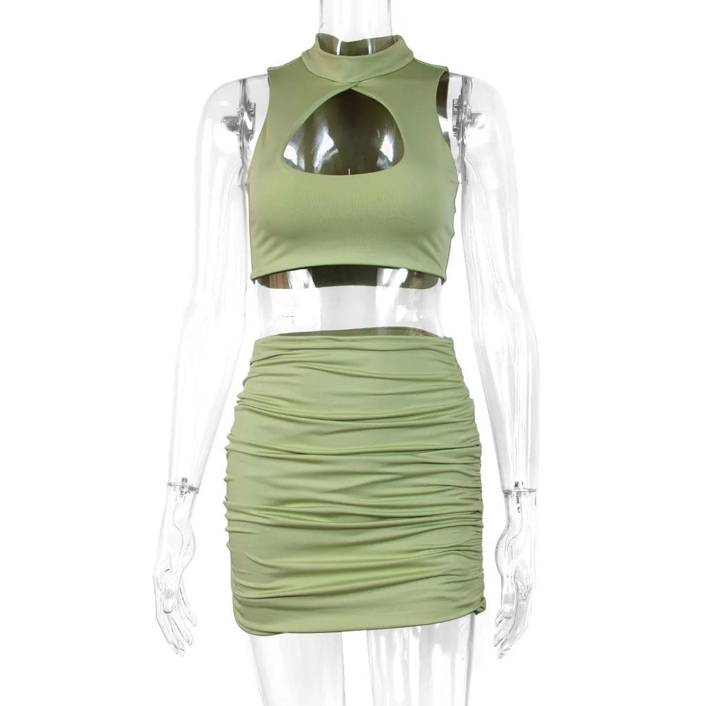 Light purple women's two-piece set with hollow-out vest and split skirt on a model.