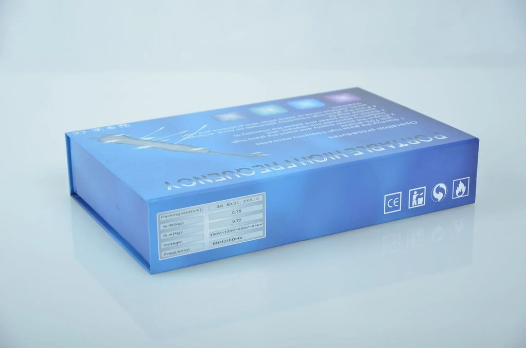 White hand held high frequency electrotherapy comb with glass tube accessories for acne and mite removal in box packaging
