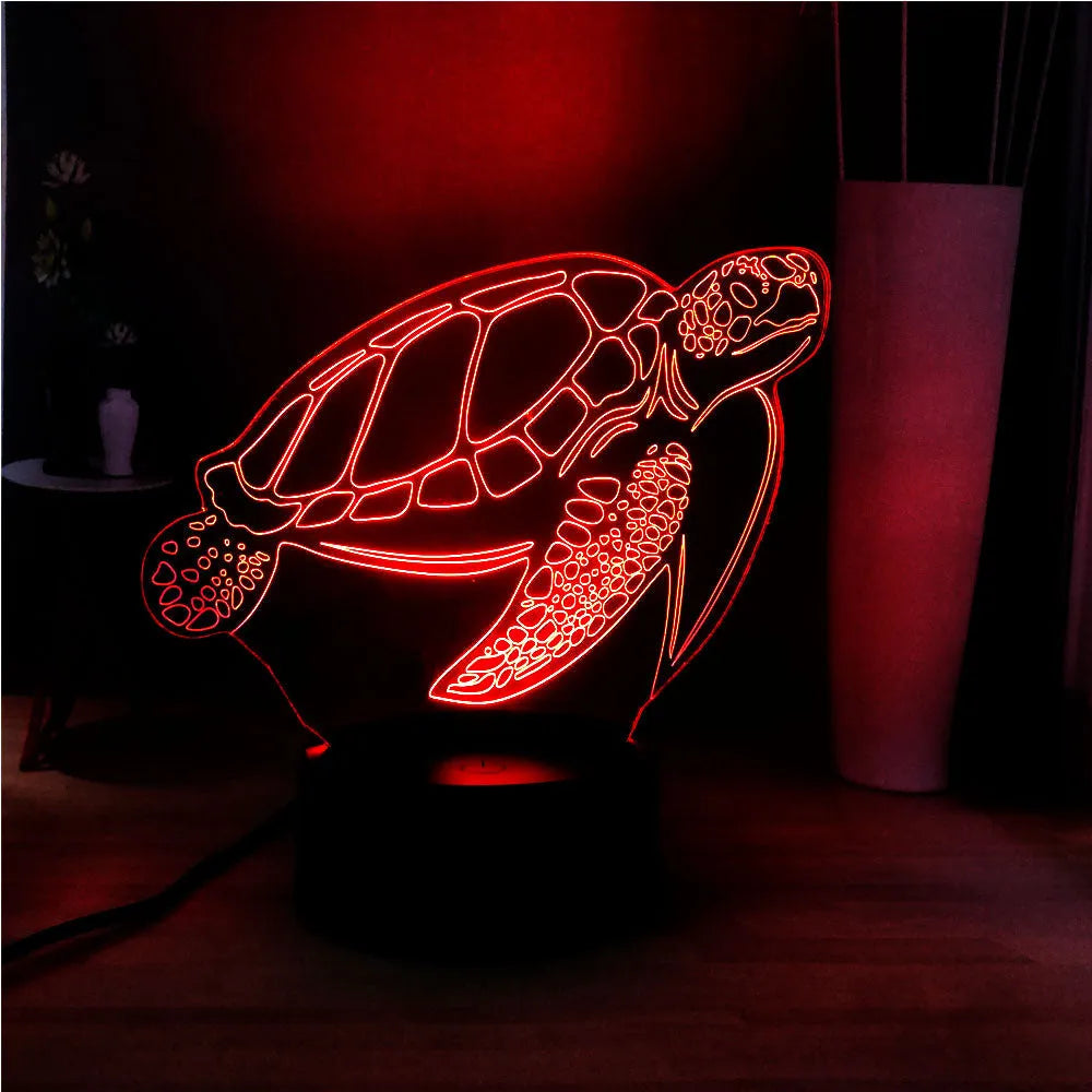 3D acrylic turtle-shaped LED night light with colour-changing modes on a table.