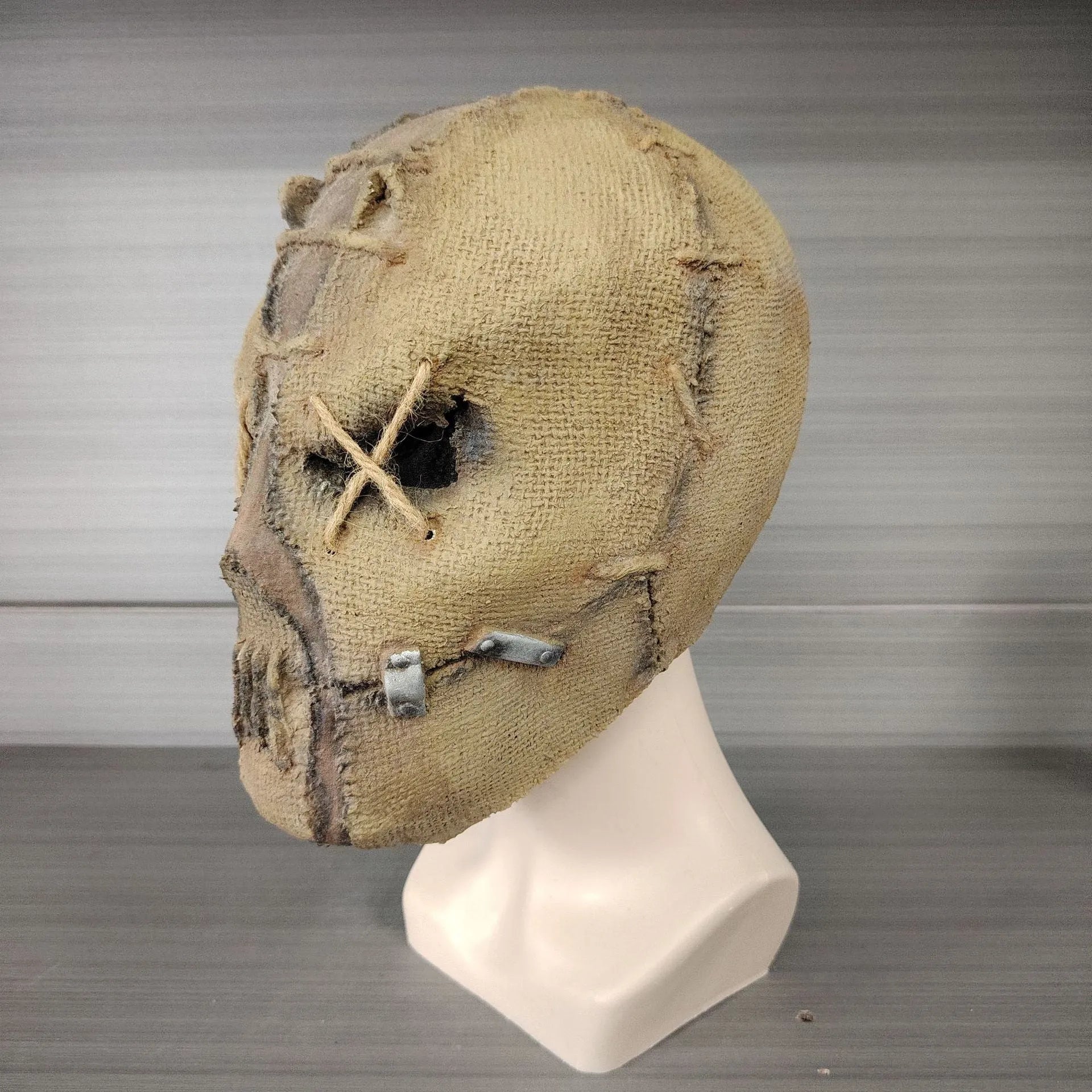 Close-up of a detailed latex scar skull mask head cover for adult Halloween costumes