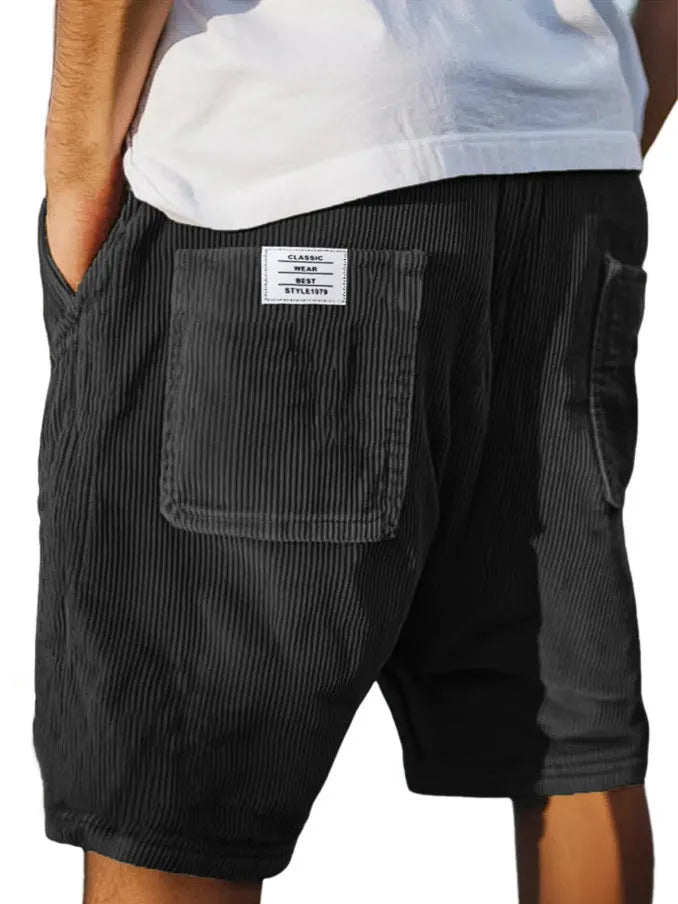 Men's grey corduroy shorts with multiple pockets and embroidery detail on leg, laid flat.