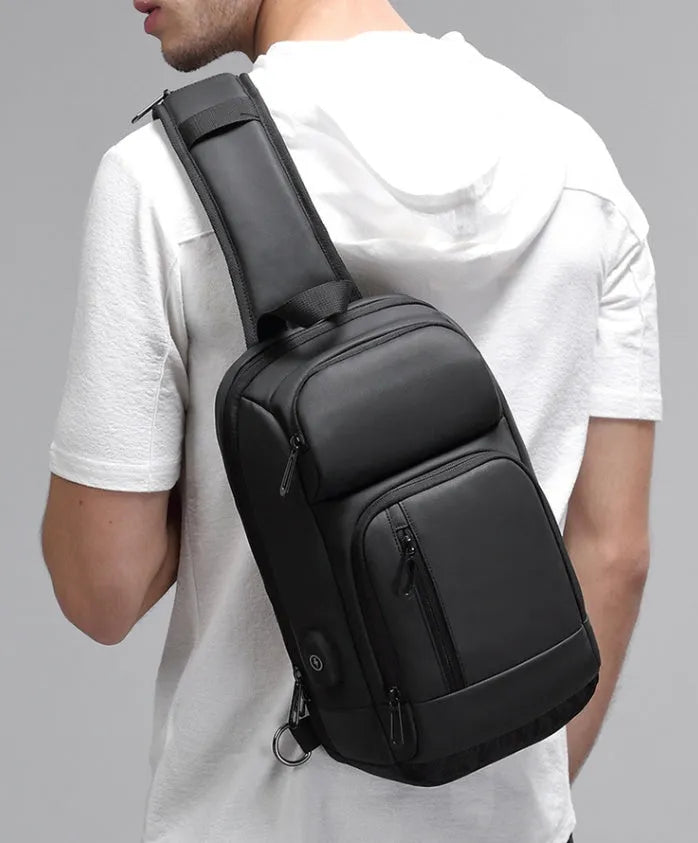 Black outdoor shoulder bag showing internal computer pocket and air cushion shoulder strap