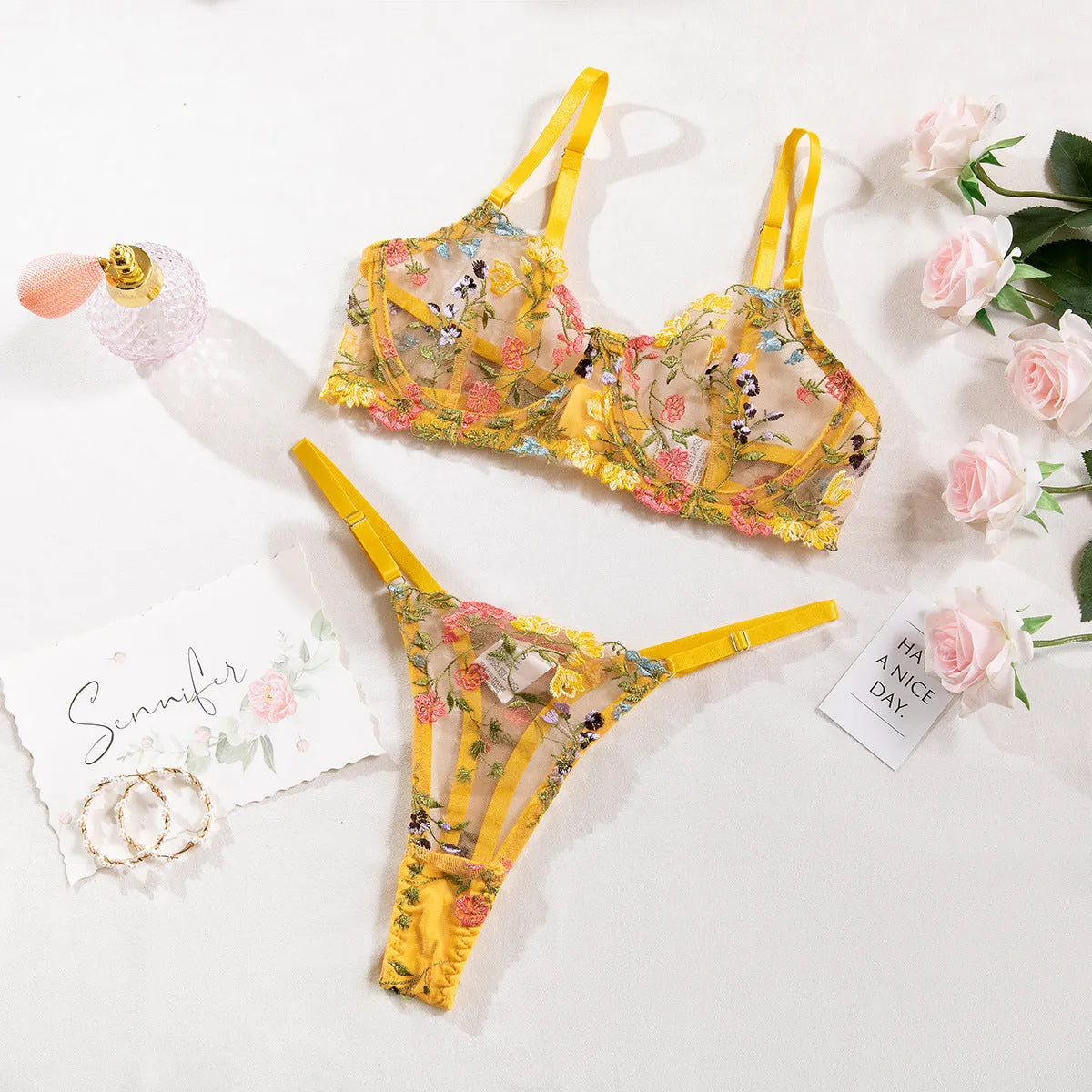 Floral patterned mesh bra with steel ring detail on T-back strap, shown in skin colour.