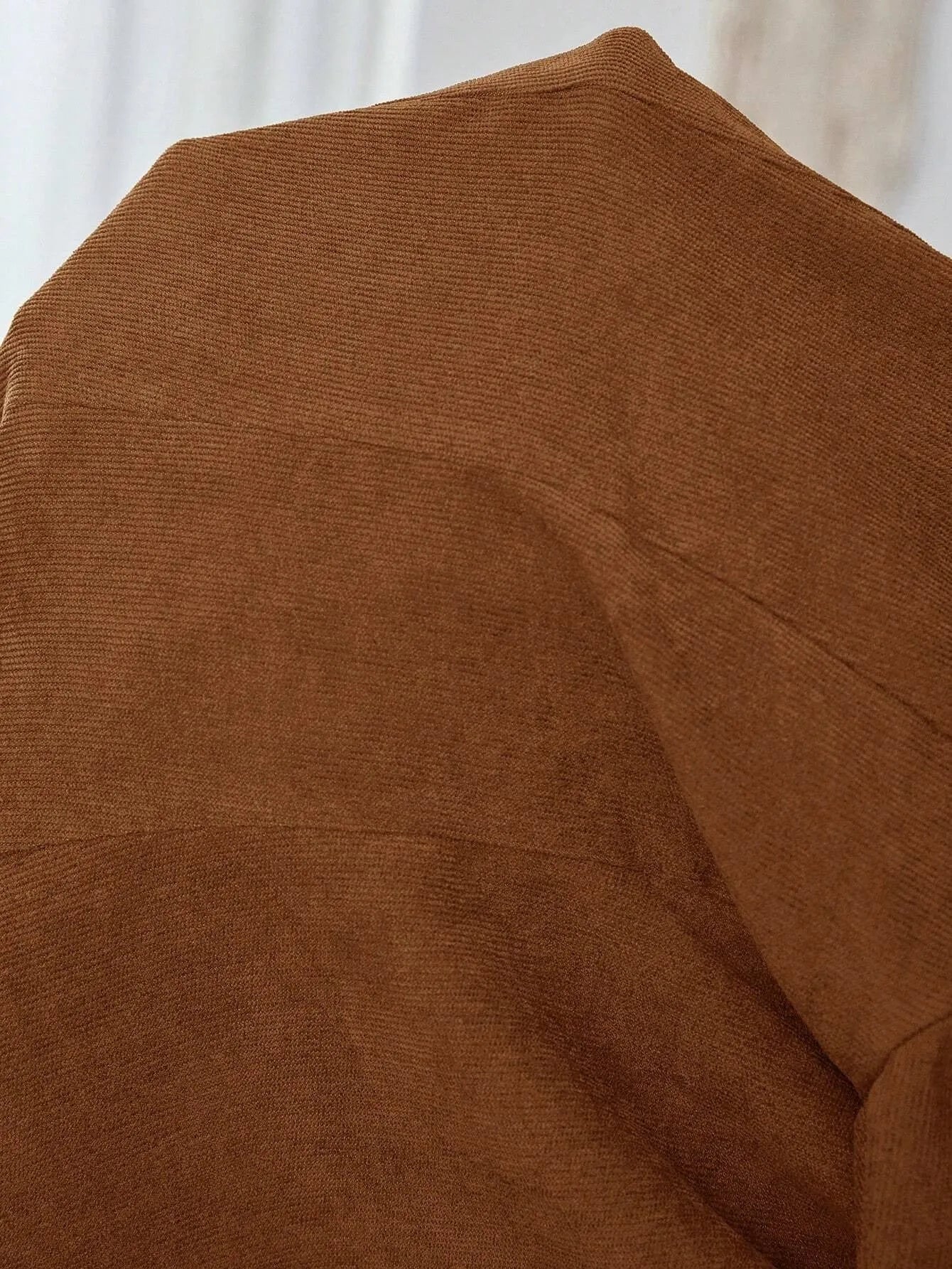 Brown single-breasted suit coat with lapel collar and long sleeves