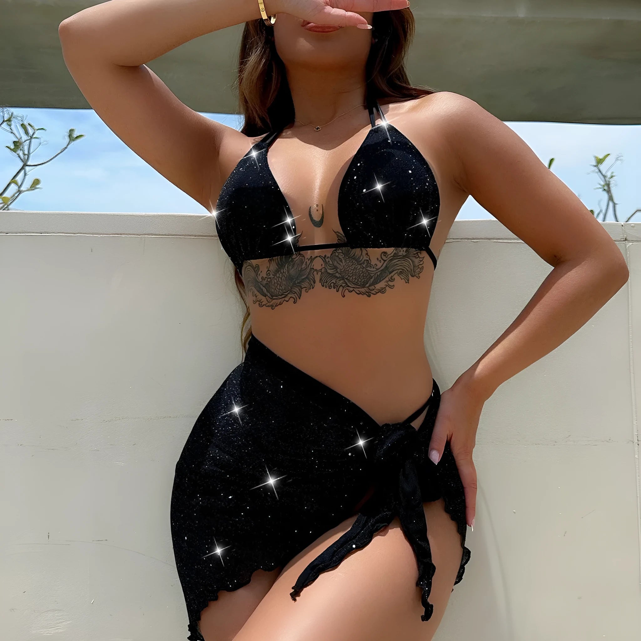 Black women's three-piece bikini swimsuit set with top and shorts.