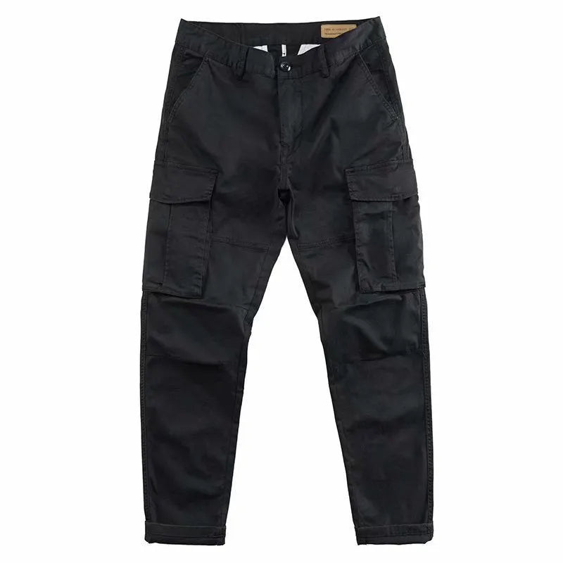 Man wearing khaki coloured multi-pocket cotton cropped work trousers.