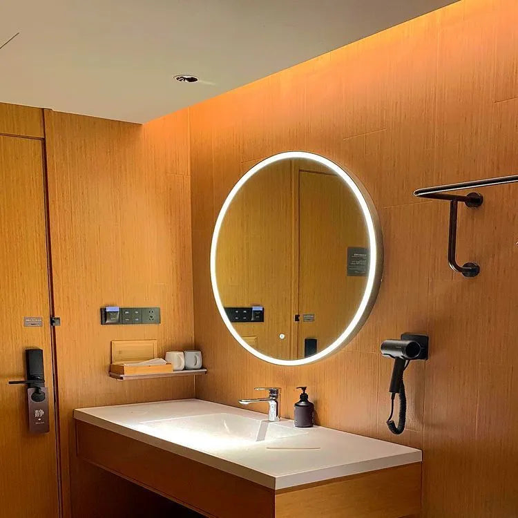 Round black aluminium frame LED bathroom mirror mounted on wall with touch control for dimmable lighting.