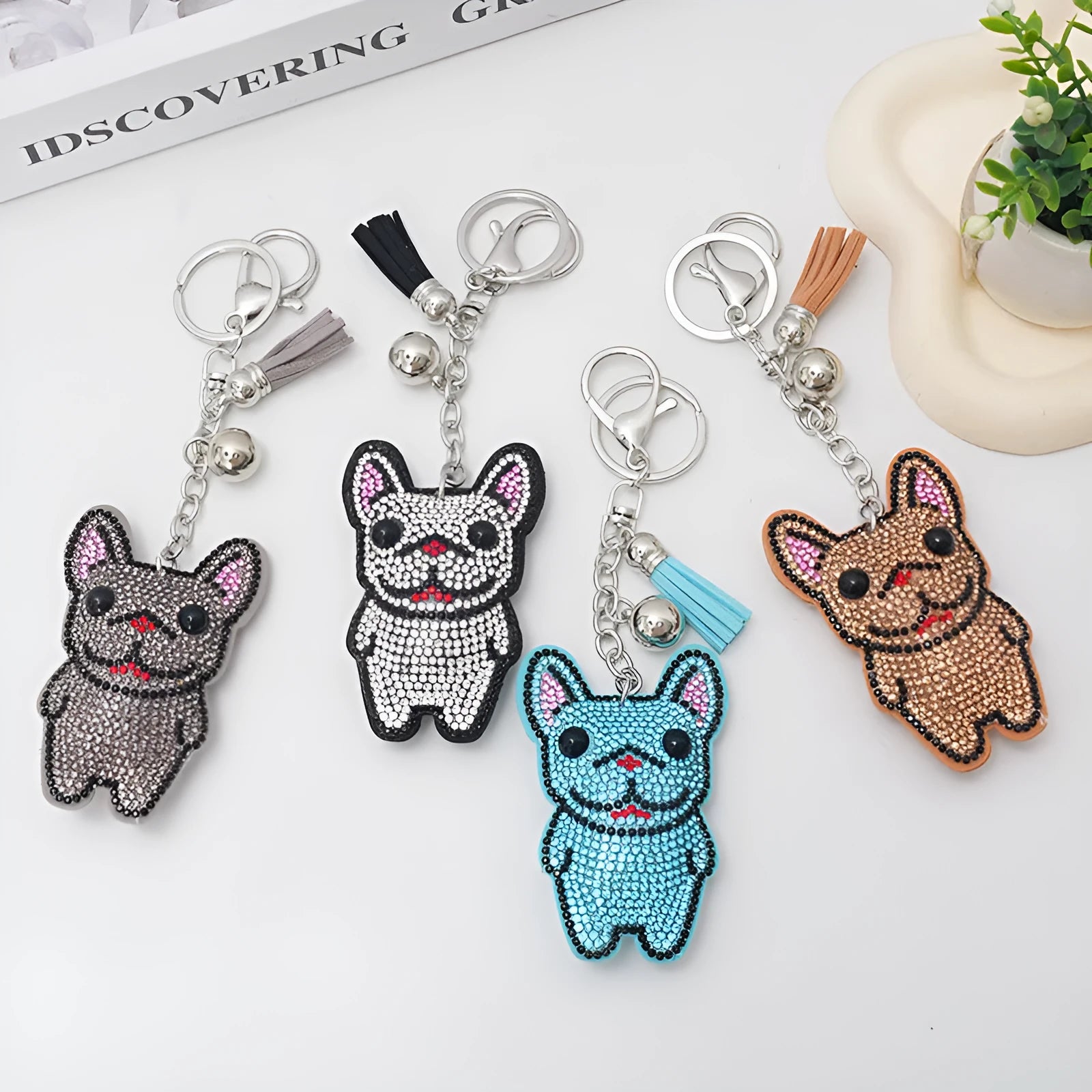 Close-up of a cartoon dog rhinestone keychain charm in alloy, showing sparkling details on a grey background.