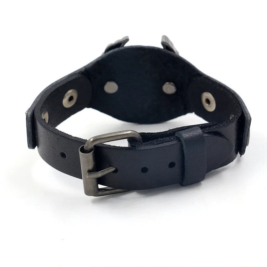 Black geometric leather bracelet with a detailed eagle watch-button clasp, shown flat.