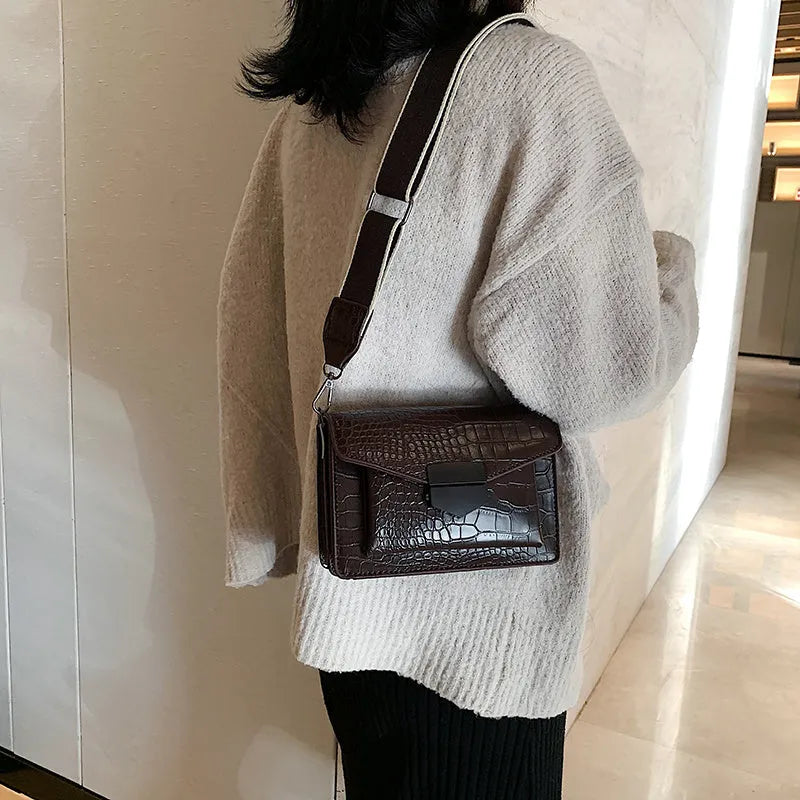 Vintage style crossbody bag in PU leather, shown in black, dimensions 20cm by 14cm.