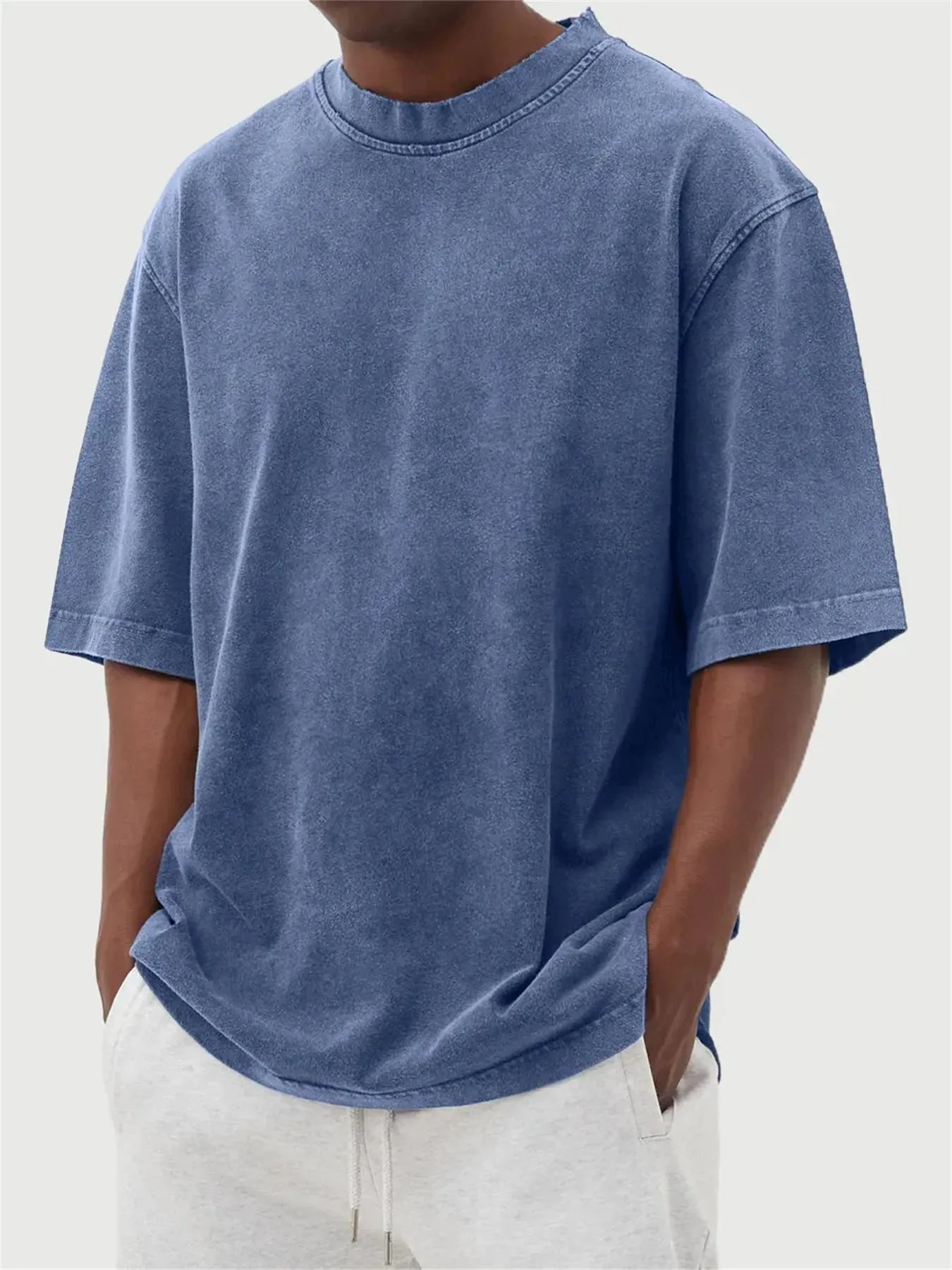Men's loose-fit stone-washed t-shirt in army green showing distressed texture and pullover style.