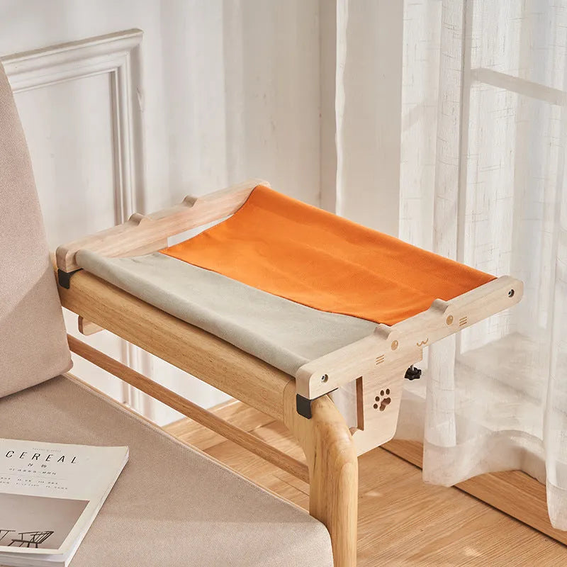 Wooden cat hanging bed hammock mounted on a balcony railing
