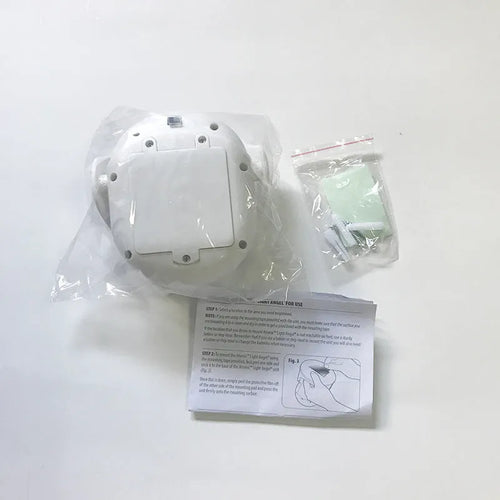 White Atomic Angel induction-powered night light with compact ABS plastic body.