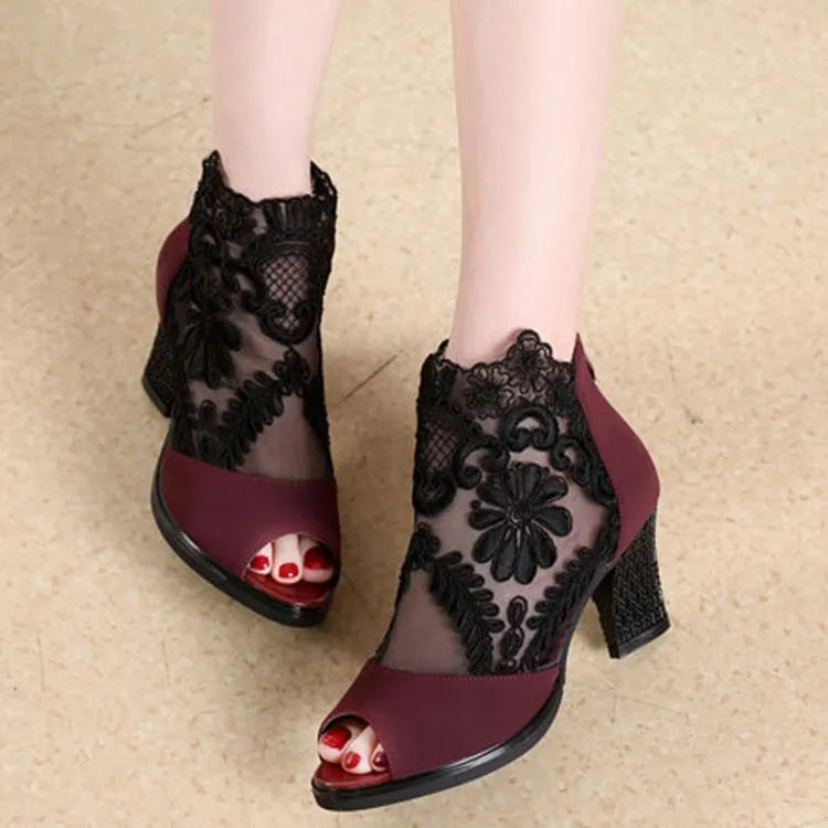 Women's black lace gladiator sandals with square heel and zip closure showing floral patterns