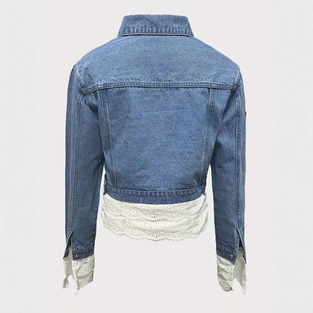 Blue women's denim jacket with lace stitching detail on the front.