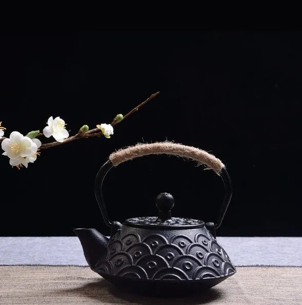 A cast iron teapot with Japanese-style hand-painted decoration, shown in a Bronze finish, with a capacity of 0.9 litres.