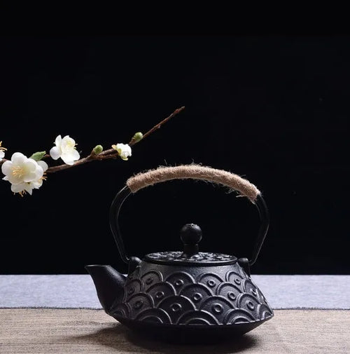 A cast iron teapot with Japanese-style hand-painted decoration, shown in a Bronze finish, with a capacity of 0.9 litres.