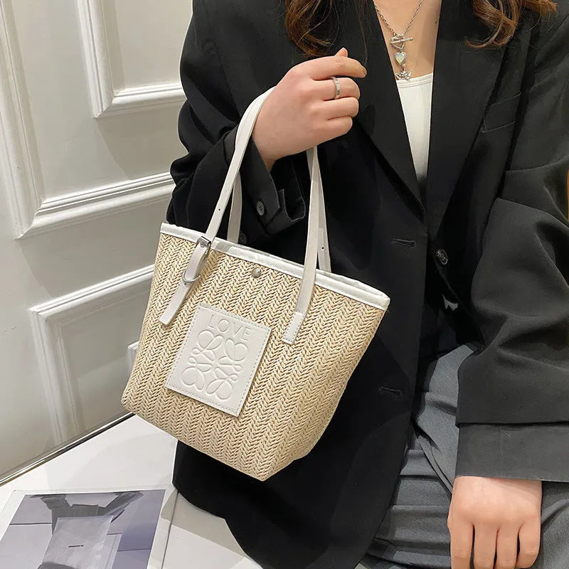 Straw woven women's shoulder bag in black with sewing thread detailing and large capacity design