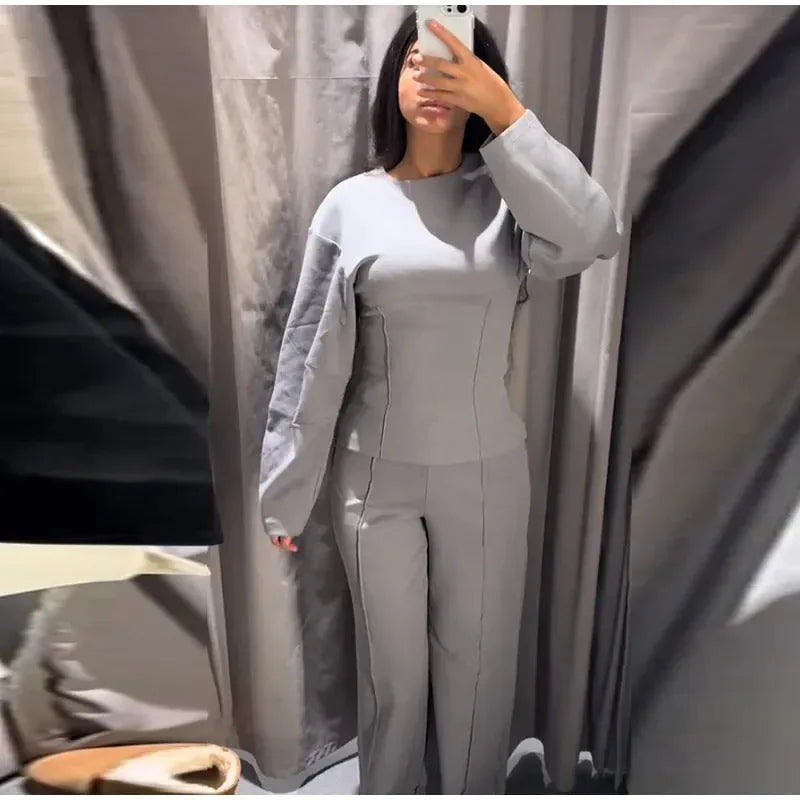 Women's apricot colour polar fleece lounge suit featuring a long sleeve pleated top and wide-leg trousers.