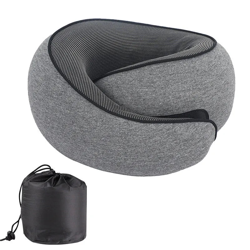 U-shaped grey memory foam travel neck pillow with a black storage bag on a plain background.