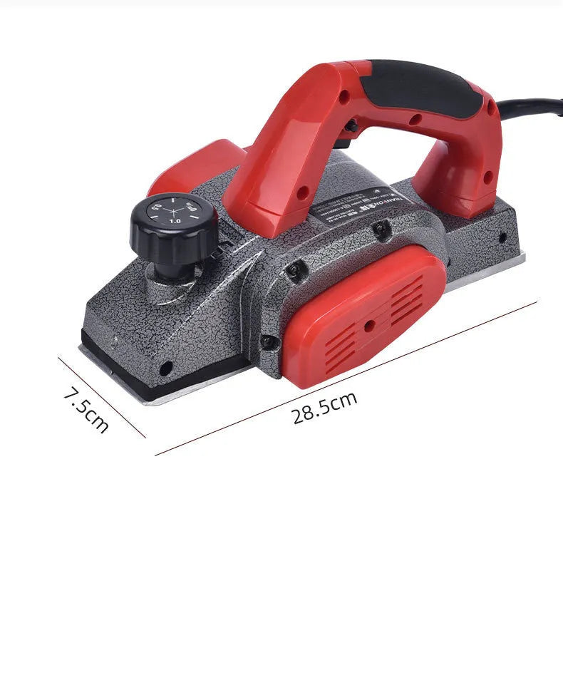 Red aluminium shell electric wood planer tool with 82mm planing width on a workbench.