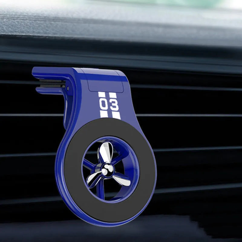 Magnetic car air vent phone holder with perfume dispenser in black, showing phone attached and fragrance slot.