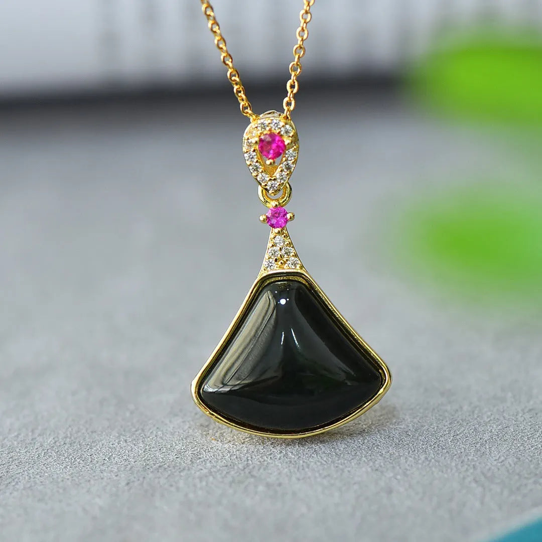 Flat gray and ink blue Hetian Jade pendant with copper inlaid decoration on a necklace.