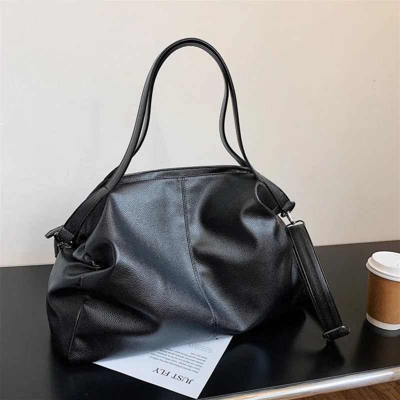 Soft surface messenger bag with adjustable strap showing mobile phone pocket and zipper compartments