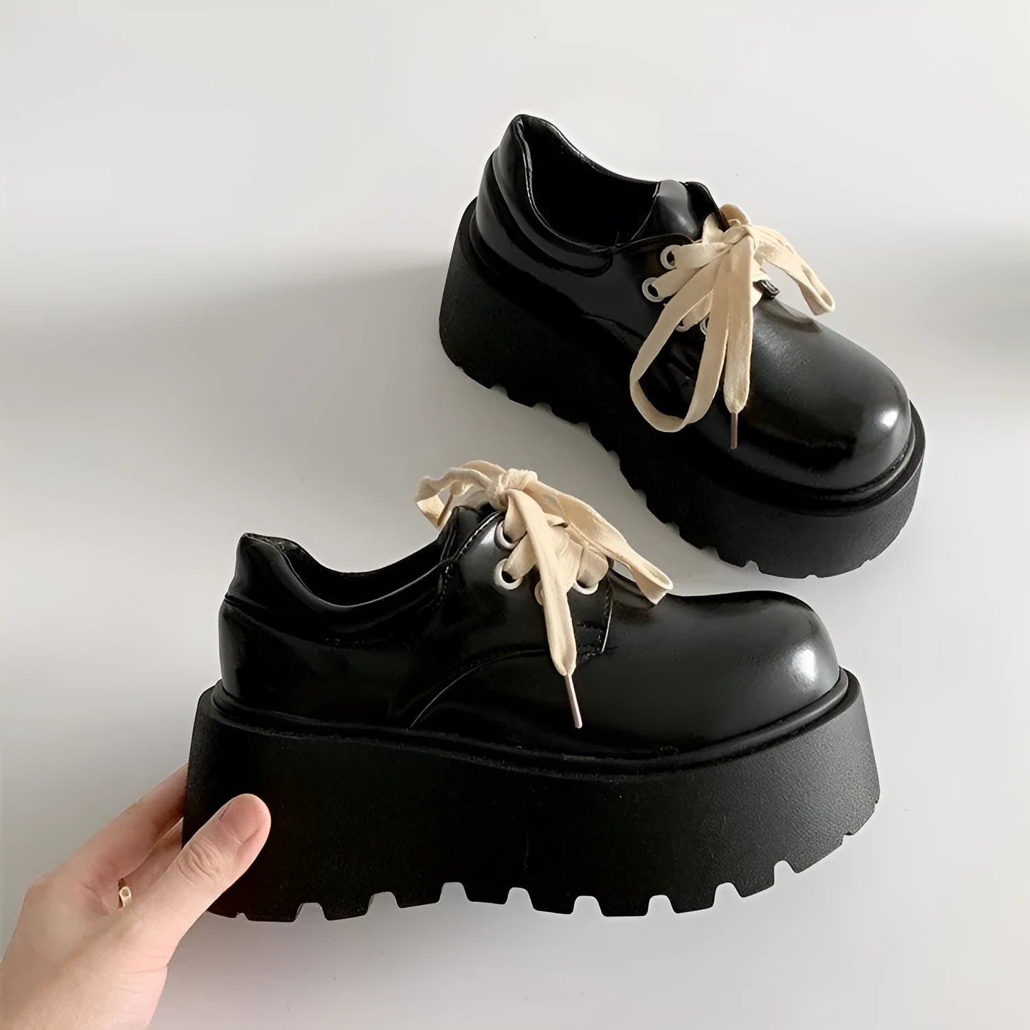 Women's matte black lace-up high heel shoes with a thick rubber sole and round toe.
