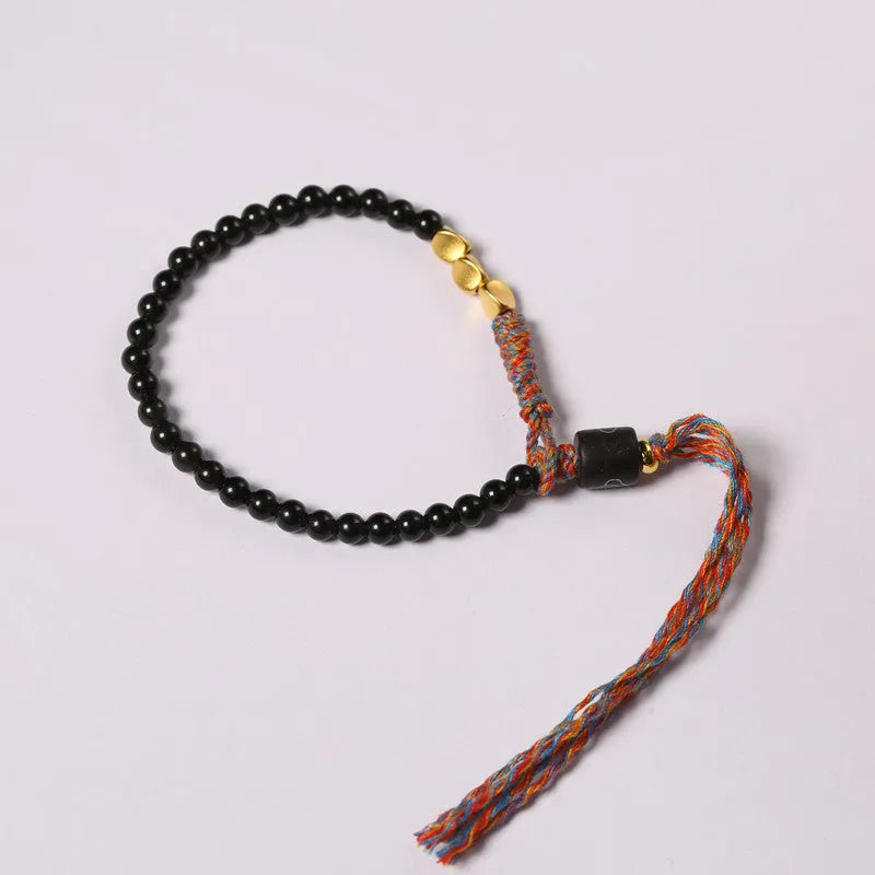Hand-woven obsidian carrying strap bracelet showing braided detail and adjustable 15.5-16cm length