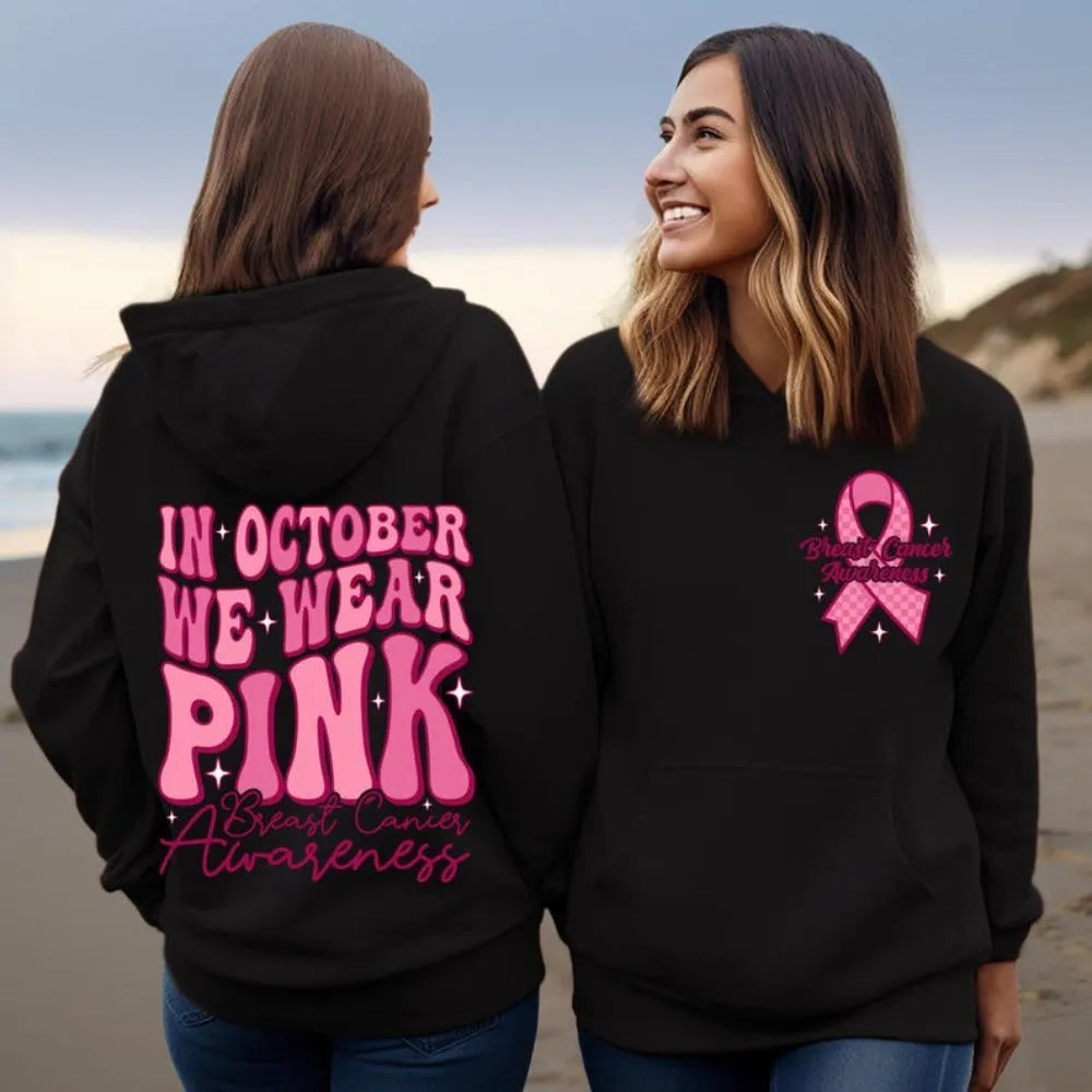 Pink pullover hoodie with a breast cancer awareness slogan, retro graphic, and side seam pockets.