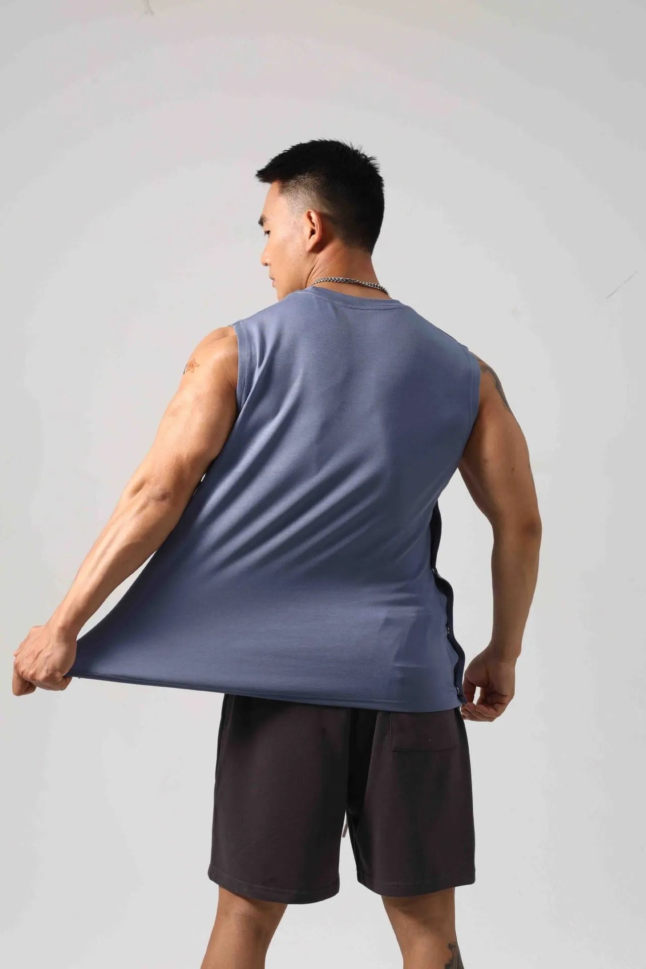 Men's black Korean style loose cotton fitness vest showing side hidden hook closure.