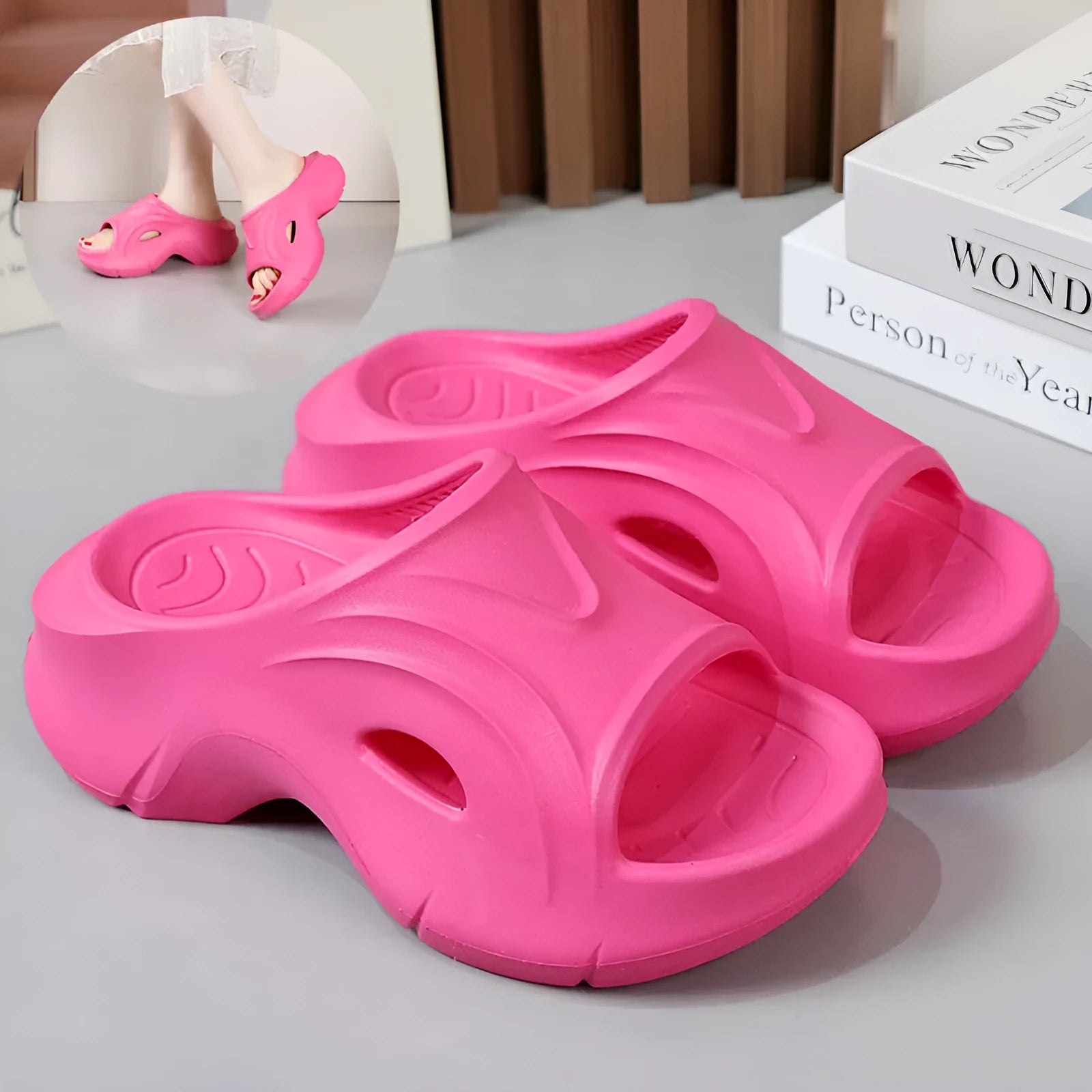 Women's white EVA slippers with a thick sole and round toe on a sandy beach.