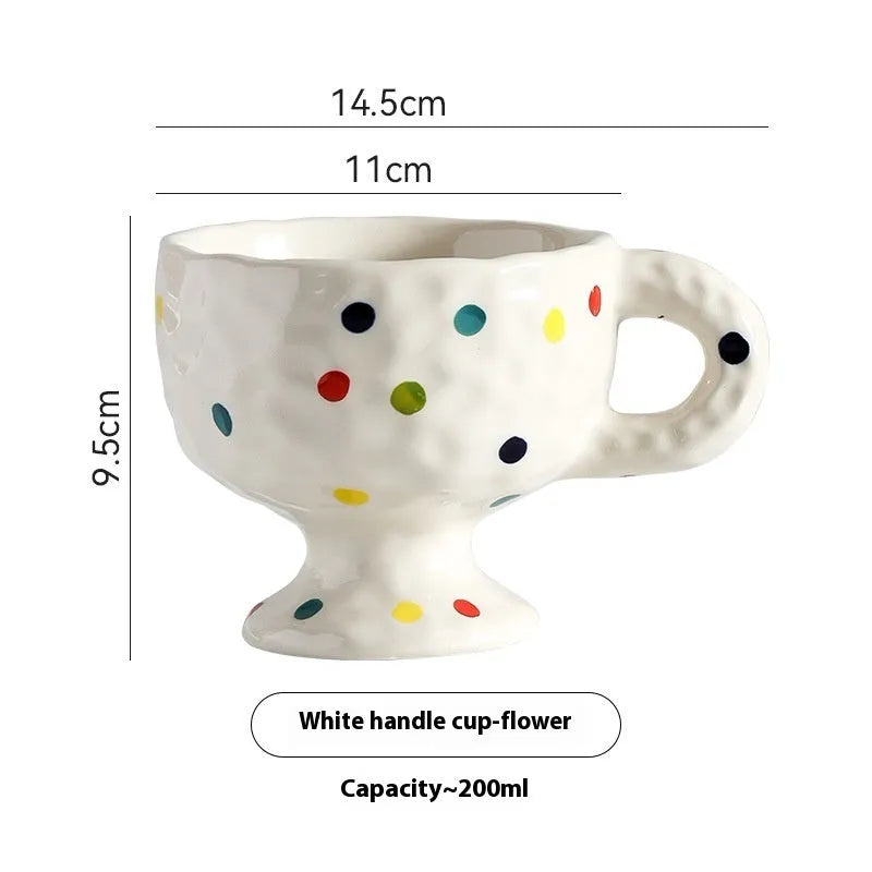 Hand-pinched irregular shaped ceramic mug in a solid colour, shown from the side.