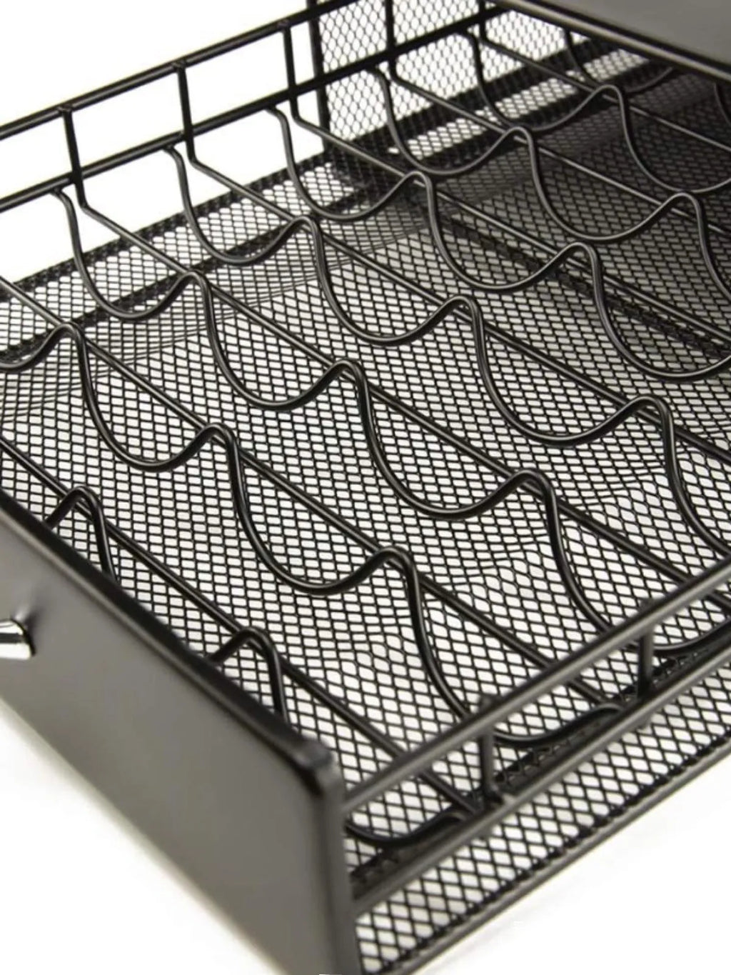 Black coffee capsule storage drawer with silver handle on a cafe countertop